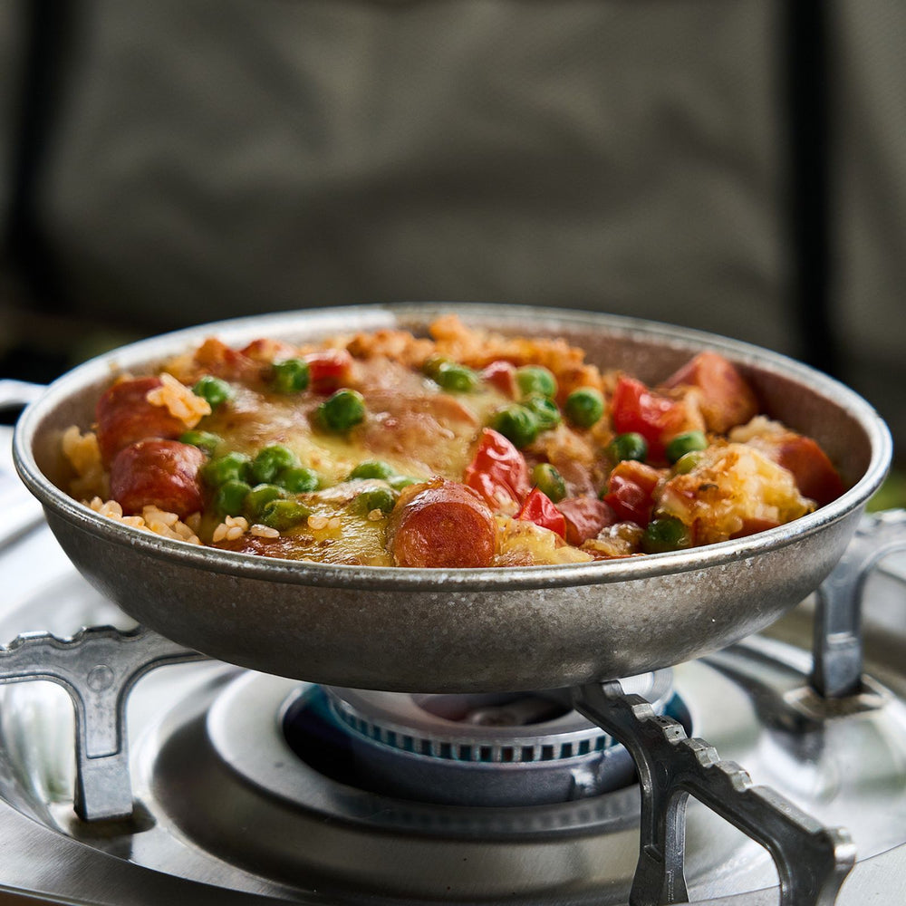 
                  
                    SilverAnt Titanium Camping Plate with a Crystallized Finish 400ml/13.53 fl oz - in use image - on a stove to heat the food in it
                  
                