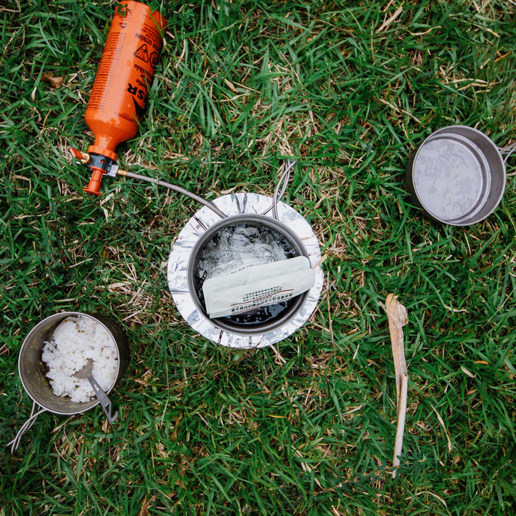 
                  
                    SilverAnt Ultralight Titanium 3-Piece Camping Cookware Set - In-Use (Top view, grass, rice, lunch, camp meal)
                  
                