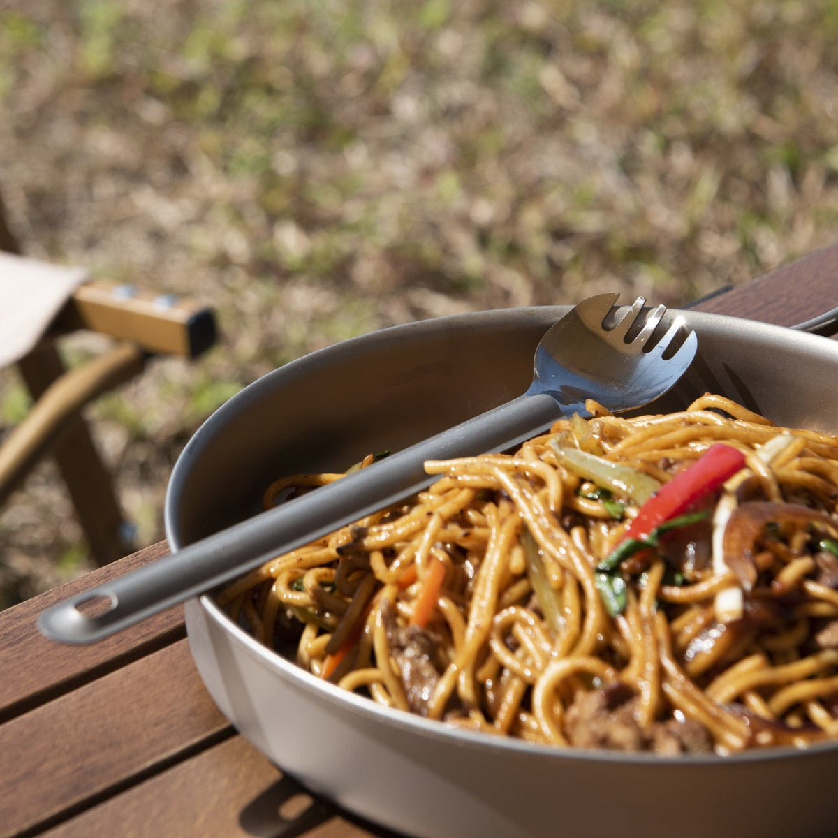 SilverAnt Ultralight Long Handle Titanium Spork Polished - Actual product photo, lifestyle shot, used for noodles