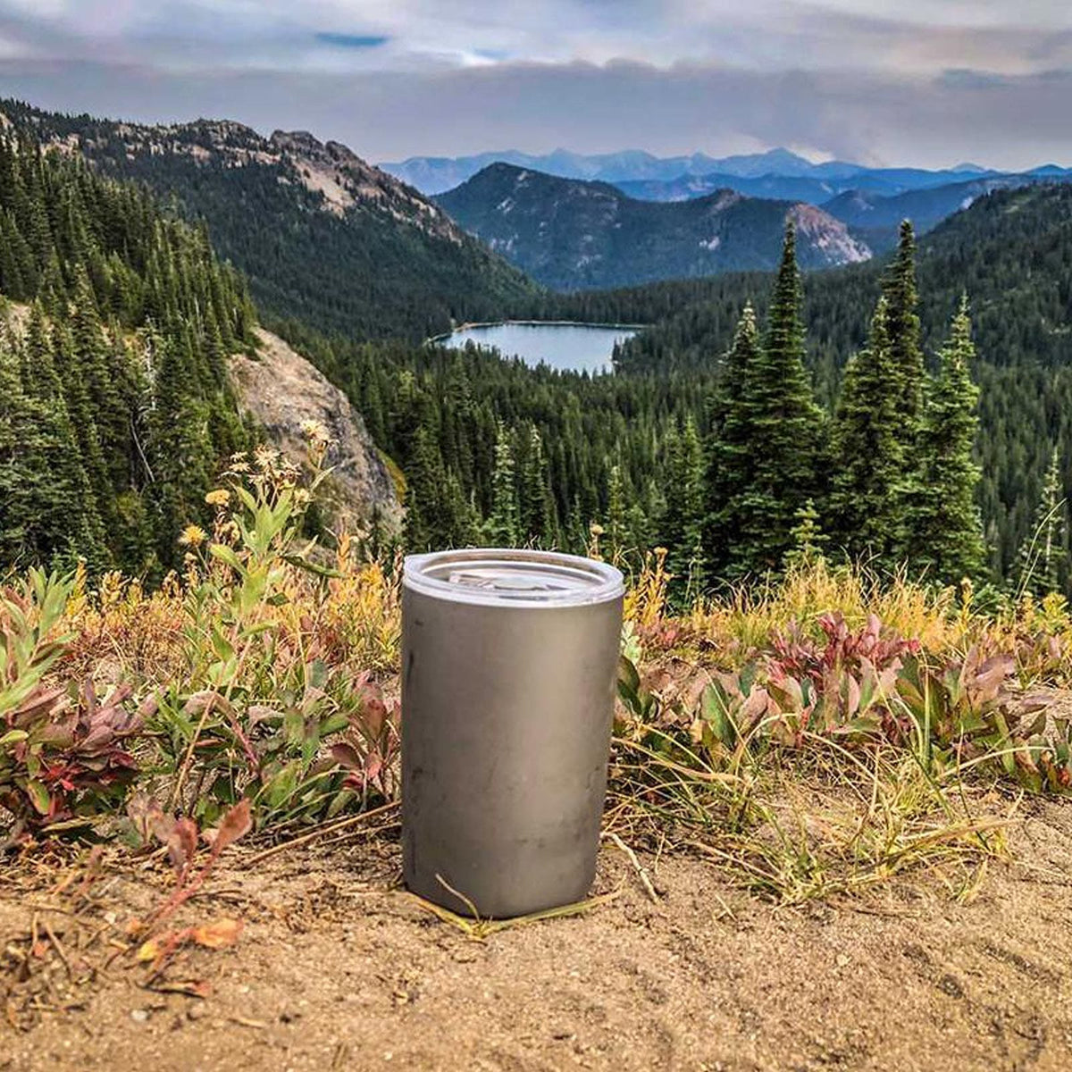 SilverAnt Ultralight Titanium Double-Wall Coffee Cup 400ml/14 fl oz Sandblasted - lifestyle shot, actual product photo, with mountains and lake in the background