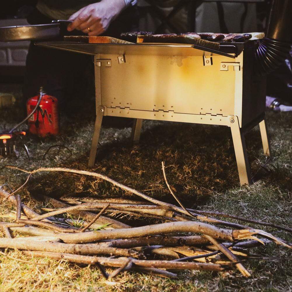 SilverAnt Ultralight Titanium Large Foldable Wood Burning Stove - Lifestyle photo, actual product photo, wooden twigs set aside for burning in the wood stove