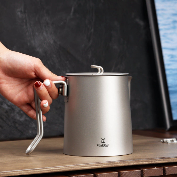 
                  
                    SilverAnt Ultralight Titanium Pour Over Short Spout Kettle with Filter 900ml/31.6 fl oz - Actual product photo, lifestyle shot, placed on a wooden surface, on hand
                  
                