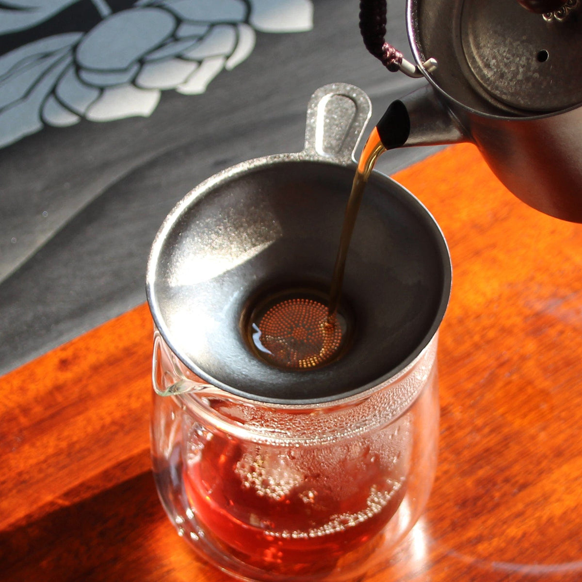 SilverAnt Ultralight Titanium Tea Filter Crystallized - actual product photo, in-use, real life, filtering tea onto a glass 