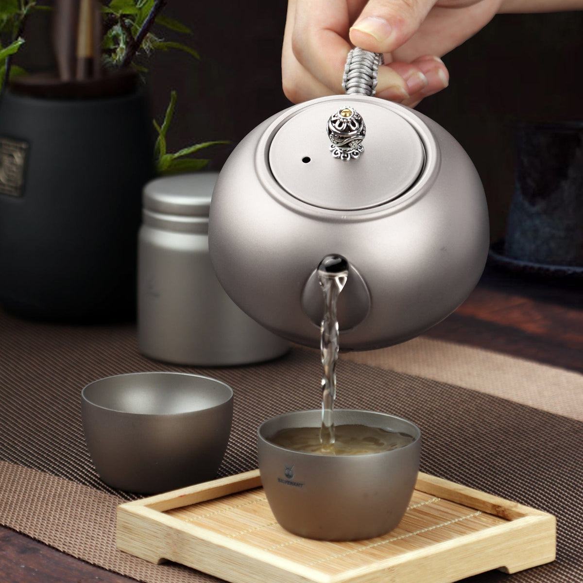 SilverAnt Ultralight Titanium Teapot & Traditional Tea Set - actual product photo, real life use, lifestyle shot, professional photo, pouring tea onto cup