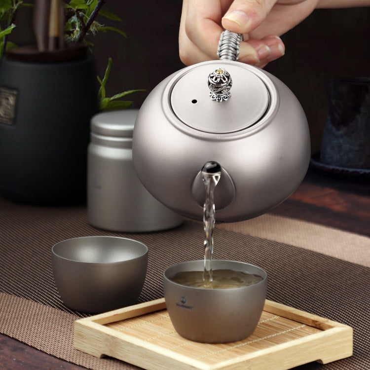 
                  
                    SilverAnt Ultralight Titanium Teapot & Traditional Tea Set - actual product photo, real life use, lifestyle shot, professional photo, pouring tea onto cup
                  
                