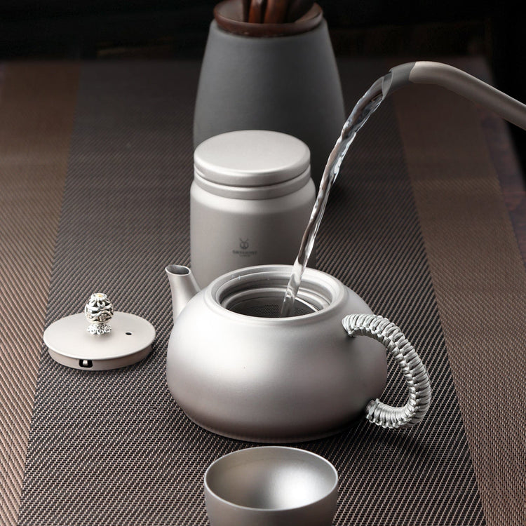 
                  
                    SilverAnt Ultralight Titanium Teapot & Traditional Tea Set - actual product photo, lifestyle shot, pouring water onto tea pot, professional shot, real life, in-use
                  
                
