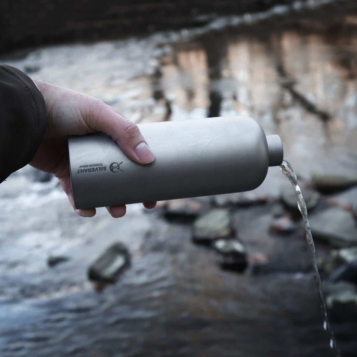 SilverAnt Ultralight Titanium Water Bottle Narrow Mouth Design - 600ml/21.1 fl (actual product photo, on-hand, in-use, pouring water out of the bottle)