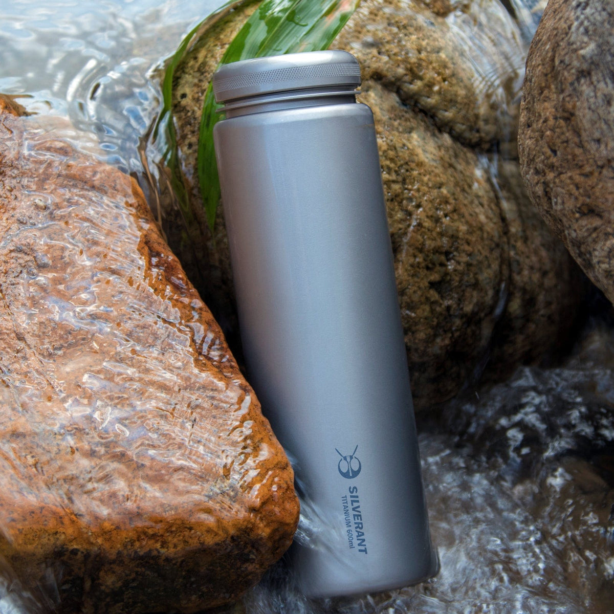 SilverAnt Ultralight Titanium Water Bottle Wide Mouth Screw Top - 600ml/21.1 fl oz (actual product photo, lifestyle shot, placed in river, water running through from behind)