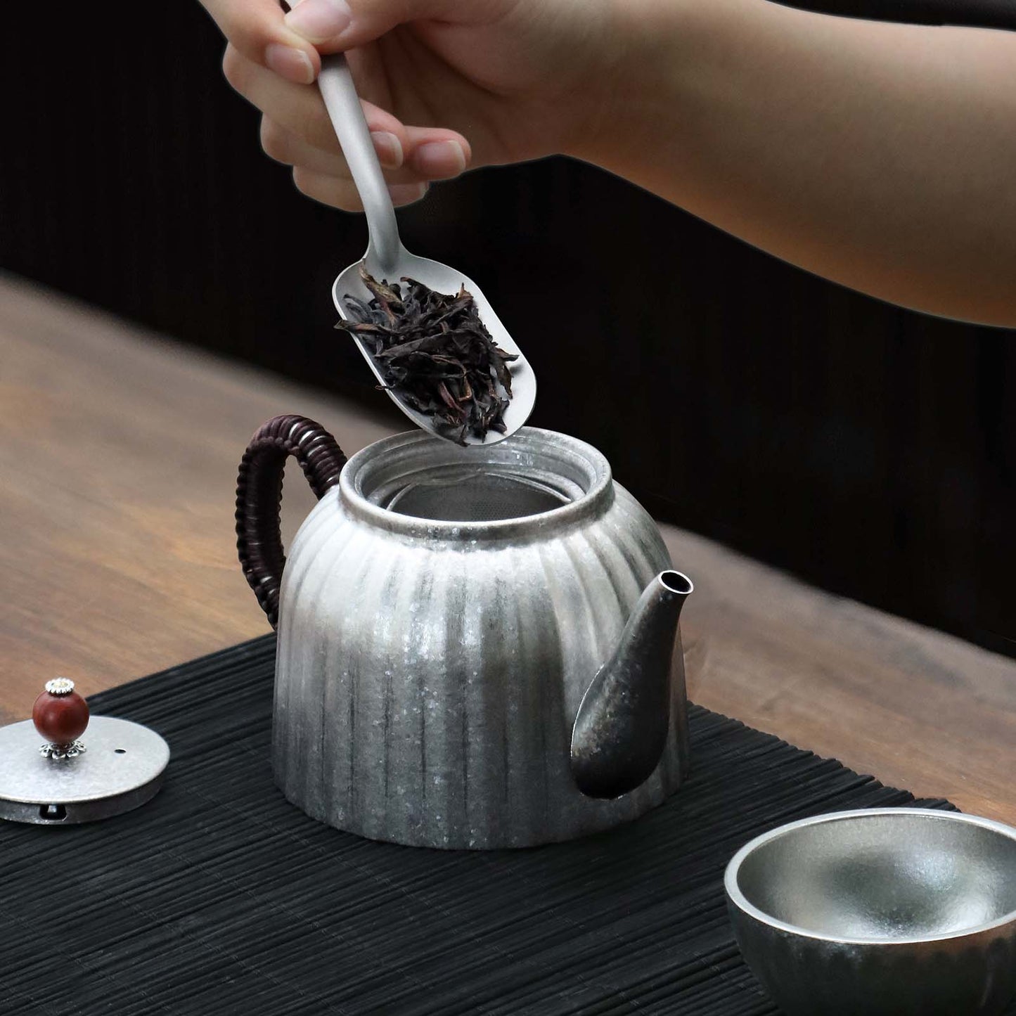 
                  
                    Titanium Pour Over Tea Pot 400ml/14fl oz - adding tea leaves into the tea pot
                  
                